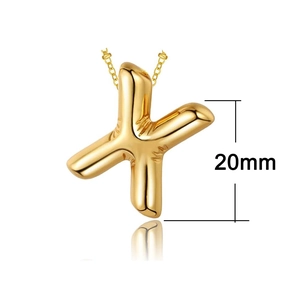 Macro shot of 20mm gold-plated bubble letter X pendant showing 3D glossy metallic texture