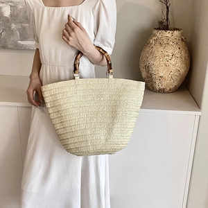 French style straw woven tote bag with bamboo handles for summer beach vacation use
