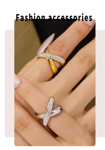 Detail of interlocking X-shaped rings in gold and silver finish with pavé set crystals