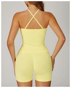 Detailed back view of light yellow ribbed yoga set showing cross-back bra and shorts
