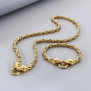 Detail of golden Byzantine chain jewelry set with intricate double snake head clasps