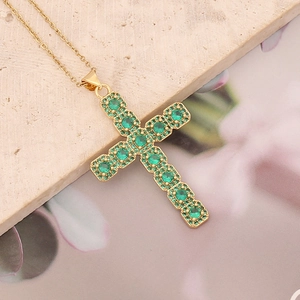 Cross pendant necklace in gold finish with round green zircon stones on stone base