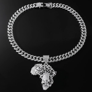 Macro detail of silver leopard head pendant with sparkling rhinestones on Cuban link chain
