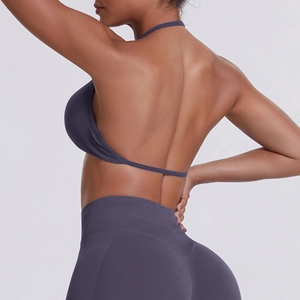 Detail of dark purple backless halter sports bra and high-waist shaping yoga leggings