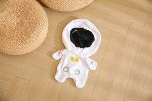 Detailed close-up of white astronaut plush outfit for 20cm cotton dolls on wood floor