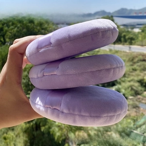 Close-up of three oversized purple velvet powder puffs with ribbon handles set of 3