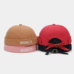 Detail of adjustable metal buckle and Brooklyn embroidery on colorful cotton miki hats