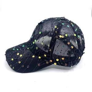 Detail of mesh baseball cap with black floral appliques and iridescent sequins