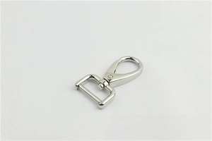 Close-up of silver metal lobster clasp with rotatable D-ring for handbag strap hardware