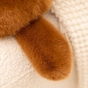 Macro shot of soft caramel plush fur texture and high-quality synthetic fibers on toy