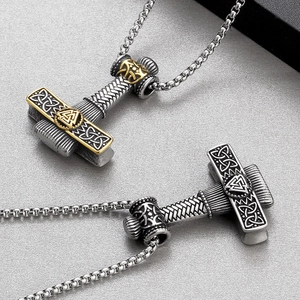 Close-up of Viking Thor's Hammer pendants with Celtic knots on stainless steel box chains