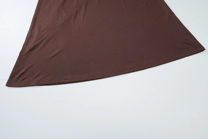 Detailed close-up showing the double-needle stitching and fabric texture of the brown dress