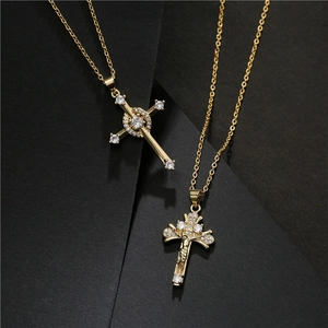 Gold necklaces with AAA zircon inlaid cross pendants on a dark textured background