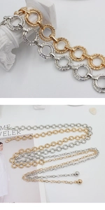 Detail of adjustable metal ring chain belt in gold and silver finish with lobster clasp