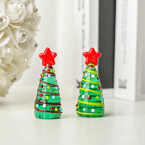 Detail of mini glass Christmas trees with red star topper and colorful dot accents