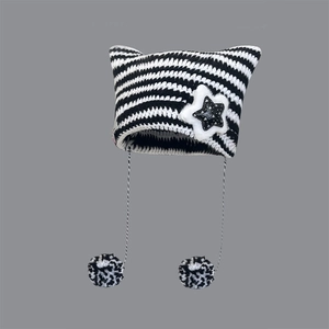 Striped knit beanie with cat ears, star patches and pom-pom ties on gray background