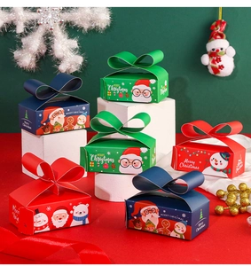 Detailed view of Christmas candy boxes with 3D paper bow lids and festive illustrations