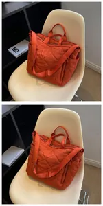 Close-up of quilted tote bag with diamond stitching and adjustable wide shoulder strap