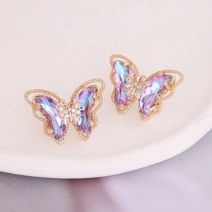Macro shot of gradient butterfly stud earrings with colorful crystals and gold trim
