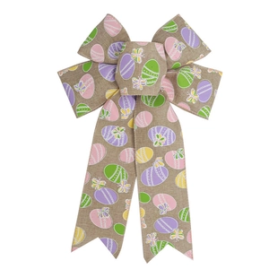 Detail of burlap Easter bow featuring colorful egg and butterfly prints on natural texture