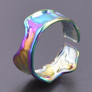 Detailed macro shot of irregular wave texture on rainbow plated stainless steel ring