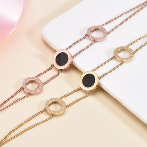 Double-layered 18K gold bracelet with Roman numerals and black shell circular pendant