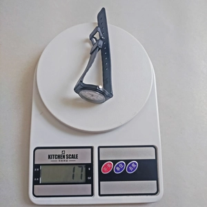 Minimalist black quartz student watch weighing only 17g on a digital scale for exams