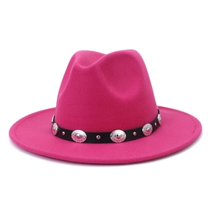 Close-up of rose red wool fedora hat featuring a black leather belt with silver studs