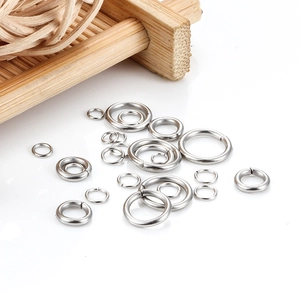Various sizes of stainless steel open jump rings for DIY jewelry making on white background