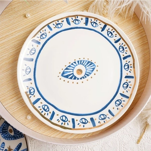 Ceramic eye plate with blue and gold Evil Eye patterns and elegant gold rim decoration