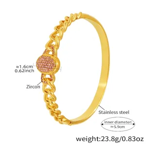 Detail of 18K gold-plated stainless steel Cuban link bracelet with pink zircon inlay