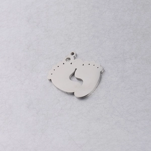 Macro shot of silver baby footprint pendant with polished finish and sparkling rhinestone