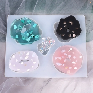 Detail view of oval resin pendants in various colors made with a silicone DIY mold
