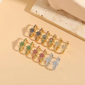 Detail of star-shaped hoop earrings with colorful zircon stones in gold and silver finish