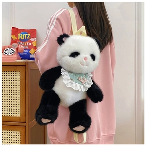 Panda plush backpack with white lace bib and pink heart detail on a model's back
