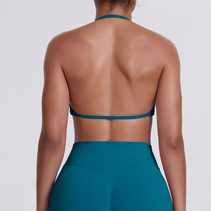 Detail view of seamless backless halter yoga bra and high waist leggings in dark teal