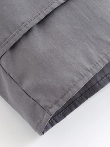 Detail of the high-quality stitching and twill fabric texture on gray short shirt
