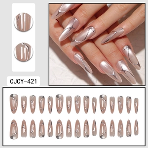 French cat eye press-on nails with liquid metal gold lines on soft pink almond shape
