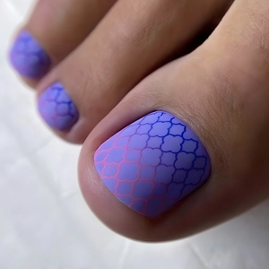 Detail of purple-blue gradient press-on toenails with geometric tile pattern matte finish