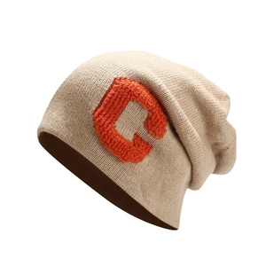 Loose knit khaki beanie with orange C letter patch and slouchy minimalist design