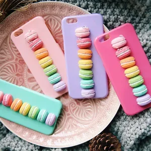 Colorful 3D resin macaron charms on cute phone cases in pink and green colors