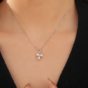 Detail shot of a cluster pearl pendant necklace with zirconia on a silver-tone chain