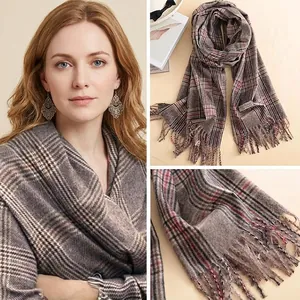Detail showing the 100% Cashmere label and classic plaid pattern on the thick winter scarf