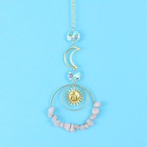 Detail of celestial suncatcher with crescent moon and pink irregular crystal stones