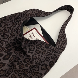 Macro view of leopard print tote bag interior showing large capacity and soft fabric texture