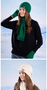 Detail of winter knitted set showing ribbed texture on beanie, scarf and gloves in snow