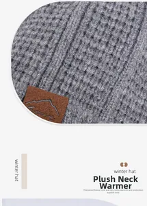 Dettaglio dello scaldacollo in maglia grigia con fodera in pile ed etichetta Sport in pelle