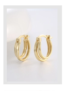 Macro shot of minimalist dual-layer gold plated S925 silver hoop earrings with a high-polished finish