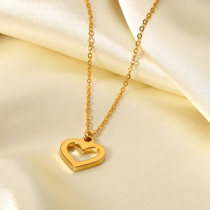 18K gold plated hollow heart necklace with clear zircon on soft beige silk background