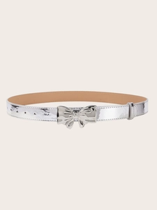 Close-up of shiny silver bow-knot buckle and metallic leather belt detail